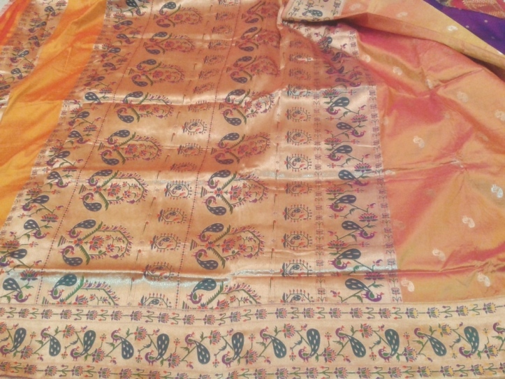 Unusual kuiri (mango) motif integrated with peacocks. Body of the sari has gold peacock boti. 